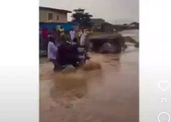 Watch moment flood sweeps bike man and passengers away (video)