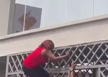 Watch video of customers climbing gates to enter banking hall (Video)