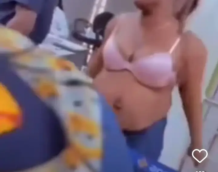 Watch moment woman pulls clothes in a bank hall over bank frustration (video)