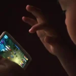 Chinese child using smartphone at night