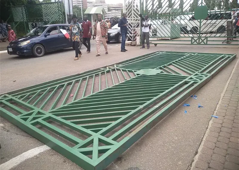 Protesters pull down National Assembly Gate in Abuja 1 Protesters pull down National Assembly Gate in Abuja
