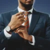 How to Command Respect African American Man in Fitted Suit Adjusting Watch Strap