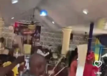 Dramatic moment members carry machetes during prayer in church (video)